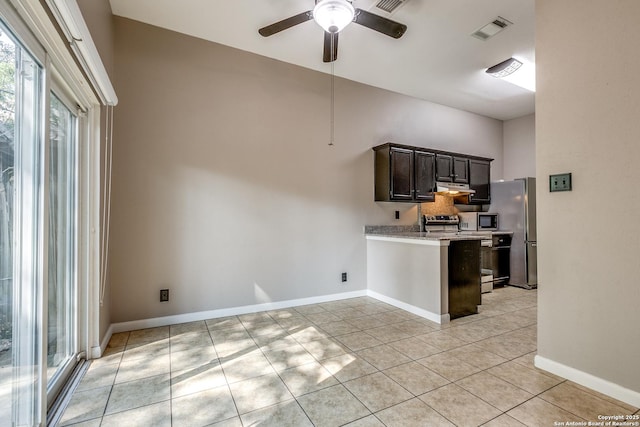 9331 Autumn Sunrise, San Antonio, TX 78254 - kitchen featuring stainless steel appliances, a ceiling fan, light tile patterned flooring, dark brown cabinets, and baseboards