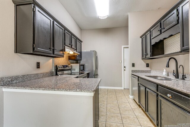 9331 Autumn Sunrise, San Antonio, TX 78254 - kitchen with a sink, stainless steel appliances, light tile patterned floors, under cabinet range hood, and a peninsula