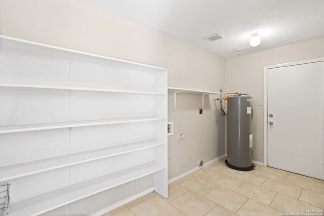 1215 Dezarae St, San Antonio, TX 78253 - washroom featuring electric dryer hookup, electric water heater, hookup for a gas dryer, hookup for a washing machine, and baseboards