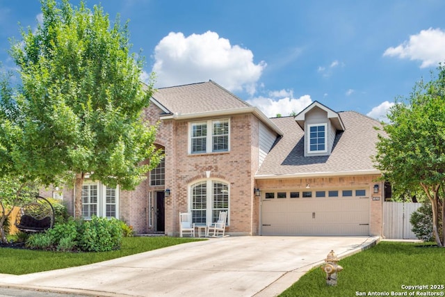 16702 Stones Throw, San Antonio, TX 78248 - view of front of house featuring driveway, brick siding, a garage, and a shingled roof