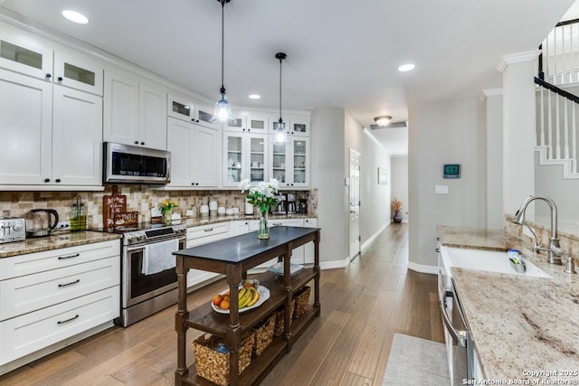 16702 Stones Throw, San Antonio, TX 78248 - kitchen featuring stainless steel appliances, a sink, tasteful backsplash, pendant lighting, and white cabinetry