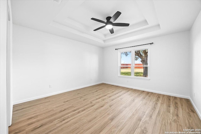 268 Cordova Loop, Seguin, TX 78155 - empty room featuring a raised ceiling, light wood-style floors, baseboards, and ceiling fan