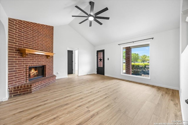 268 Cordova Loop, Seguin, TX 78155 - unfurnished living room with a ceiling fan, a brick fireplace, wood finished floors, high vaulted ceiling, and baseboards