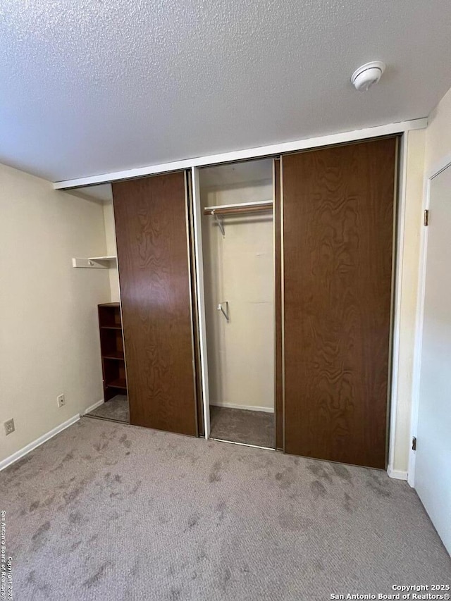 809 Marilyn, Schertz, TX 78154 - unfurnished bedroom with carpet floors, a textured ceiling, a closet, and baseboards