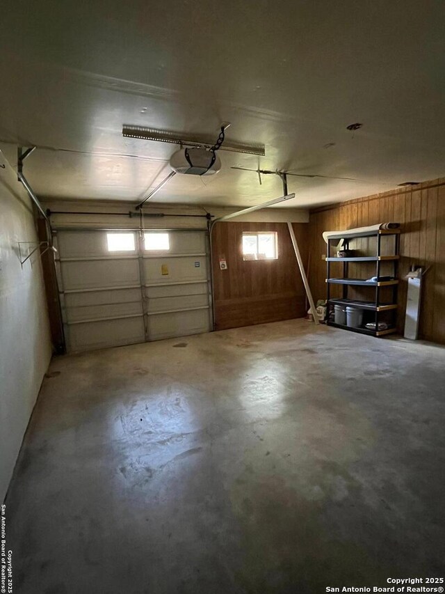 809 Marilyn, Schertz, TX 78154 - garage with wooden walls and a garage door opener