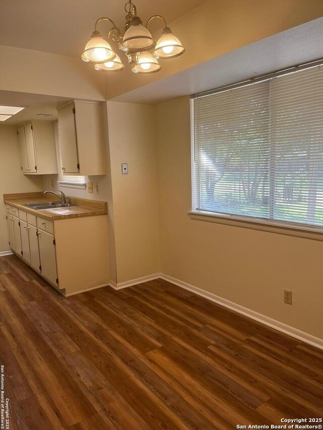 809 Marilyn, Schertz, TX 78154 - kitchen featuring a sink, baseboards, white cabinets, dark wood-style flooring, and a chandelier