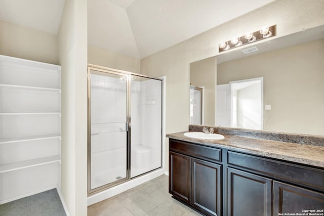 920 Bexley Dr, Seguin, TX 78155 - bathroom featuring a stall shower, vanity, lofted ceiling, and tile patterned flooring