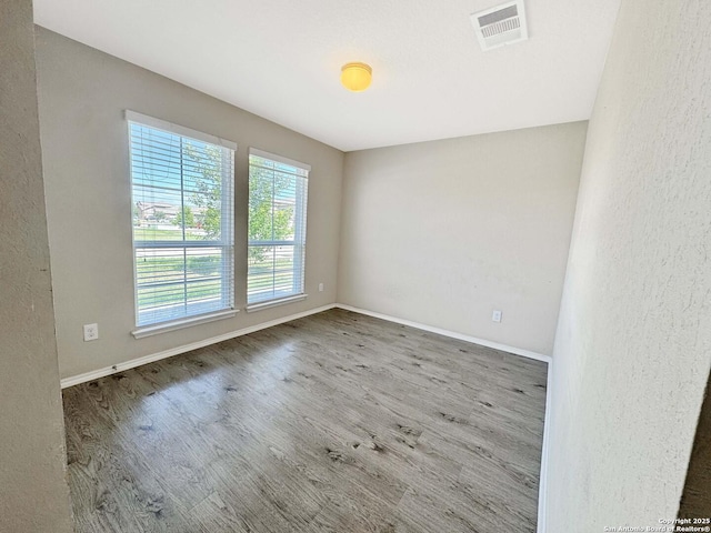 920 Bexley Dr, Seguin, TX 78155 - empty room with wood finished floors and baseboards