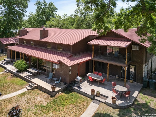 6641 Rr 1120 Unit A, B, Rio Frio, TX 78879 - rear view of property with a standing seam roof, metal roof, a patio, a chimney, and a lawn