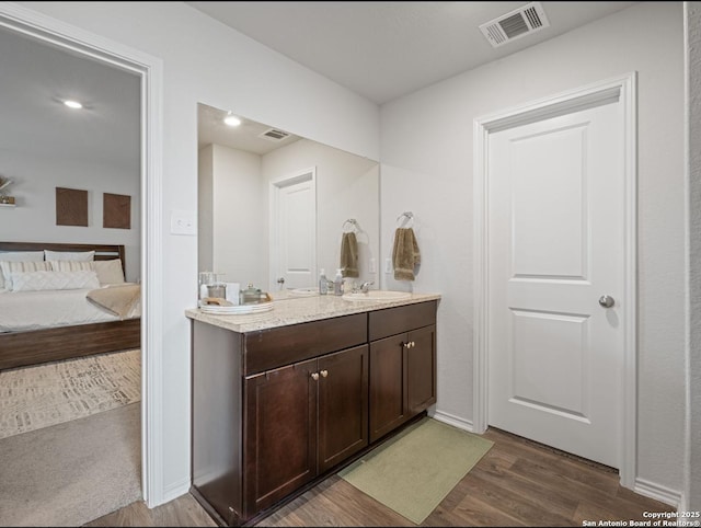 6416 Embankment, San Antonio, TX 78252 - full bathroom featuring wood finished floors, double vanity, connected bathroom, and baseboards