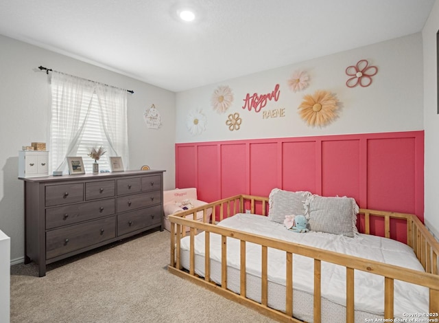 6416 Embankment, San Antonio, TX 78252 - bedroom featuring a wainscoted wall, light carpet, and a decorative wall