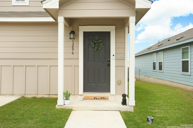 1206 Kiskadee Way, San Antonio, TX 78245 - view of exterior entry with a yard, an attached garage, and concrete driveway