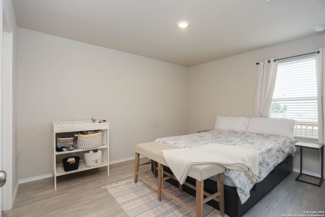 1206 Kiskadee Way, San Antonio, TX 78245 - bedroom featuring baseboards and wood finished floors