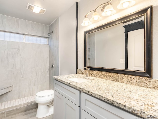 3601 Candleridge, San Antonio, TX 78244 - bathroom featuring vanity, toilet, and a tile shower