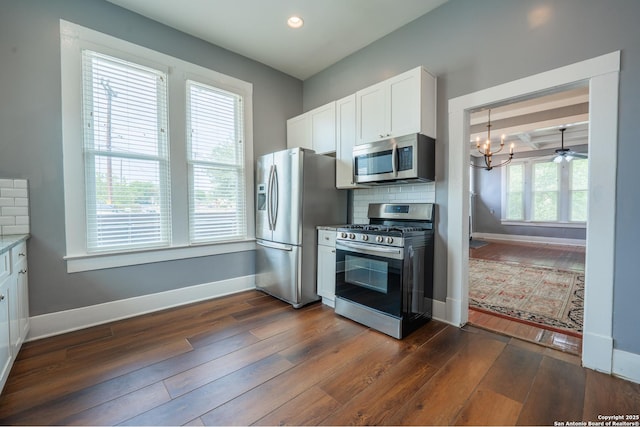 2007 S Presa, San Antonio, TX 78210 - kitchen with appliances with stainless steel finishes, baseboards, dark wood finished floors, white cabinets, and recessed lighting
