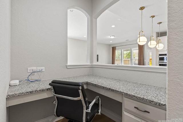 7618 Desperado, Boerne, TX 78015 - office area with built in study area, a textured wall, dark wood-style flooring, and recessed lighting