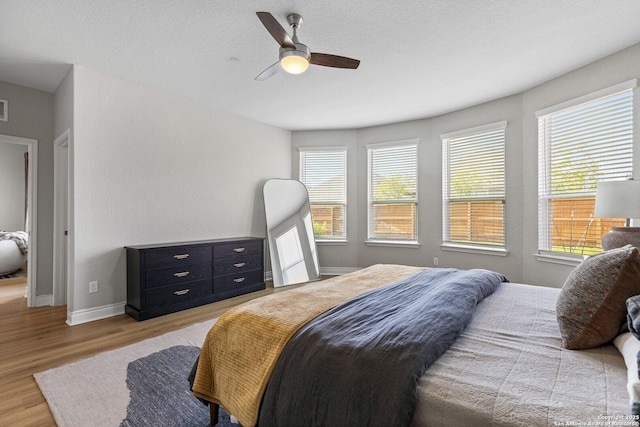 7618 Desperado, Boerne, TX 78015 - bedroom featuring wood finished floors, baseboards, and a ceiling fan