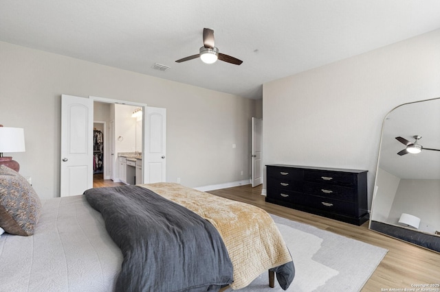 7618 Desperado, Boerne, TX 78015 - bedroom with light wood-type flooring, ceiling fan, and connected bathroom