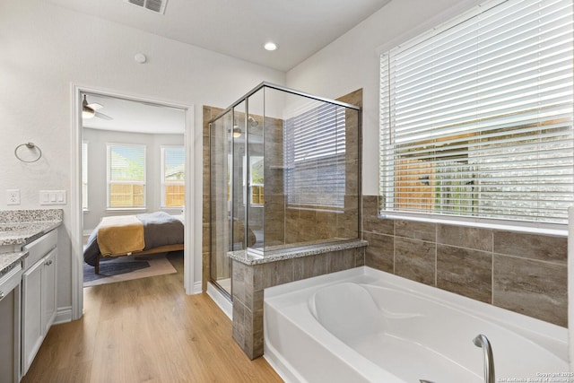 7618 Desperado, Boerne, TX 78015 - bathroom featuring a garden tub, vanity, a stall shower, wood finished floors, and connected bathroom