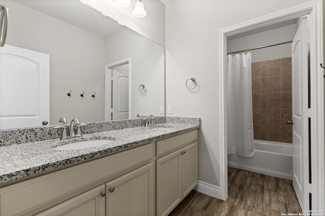7618 Desperado, Boerne, TX 78015 - bathroom featuring wood finished floors, double vanity, and shower / bath combo with shower curtain