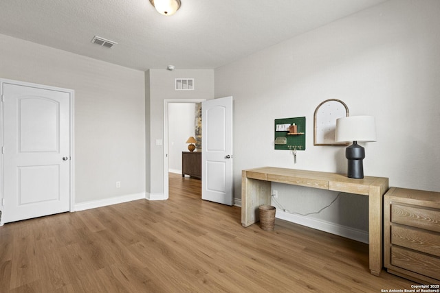 7618 Desperado, Boerne, TX 78015 - unfurnished bedroom with wood finished floors, baseboards, and a desk