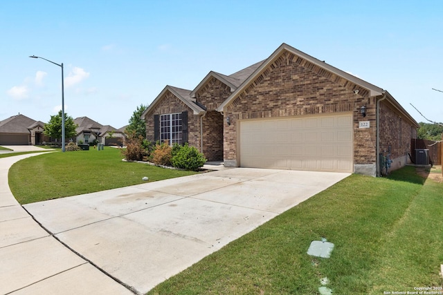122 Braeburn, Boerne, TX 78015 - view of front facade featuring an attached garage, driveway, a front yard, brick siding, and central AC unit