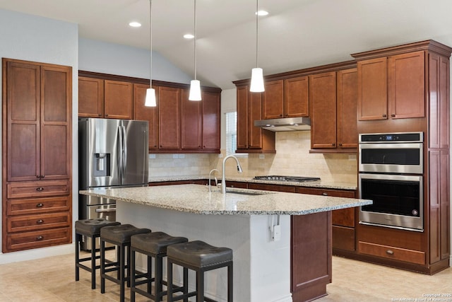 122 Braeburn, Boerne, TX 78015 - kitchen featuring stainless steel appliances, under cabinet range hood, decorative backsplash, light stone counters, and hanging light fixtures