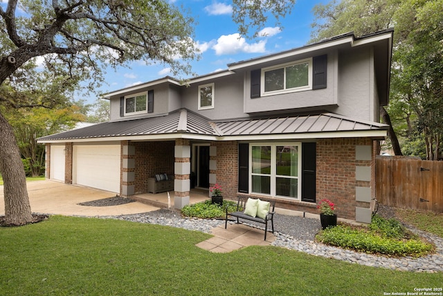 611 San Diego, San Antonio, TX 78232 - view of front facade featuring brick siding, a standing seam roof, concrete driveway, and a garage