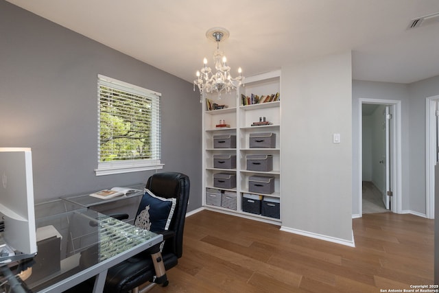 611 San Diego, San Antonio, TX 78232 - office area with wood finished floors, a chandelier, and baseboards
