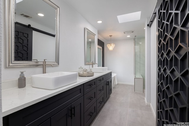 611 San Diego, San Antonio, TX 78232 - bathroom featuring double vanity, a skylight, recessed lighting, tile patterned flooring, and a shower