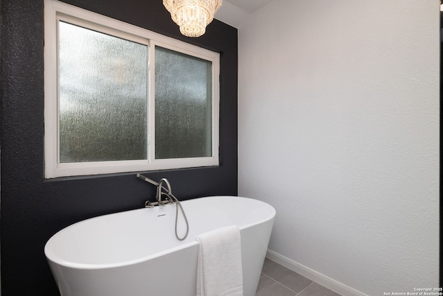611 San Diego, San Antonio, TX 78232 - bathroom with a freestanding bath, baseboards, a chandelier, and tile patterned flooring