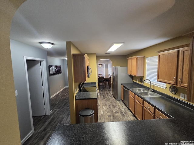 11002 Colt Chase, San Antonio, TX 78254 - kitchen featuring stainless steel appliances, a sink, arched walkways, and dark countertops