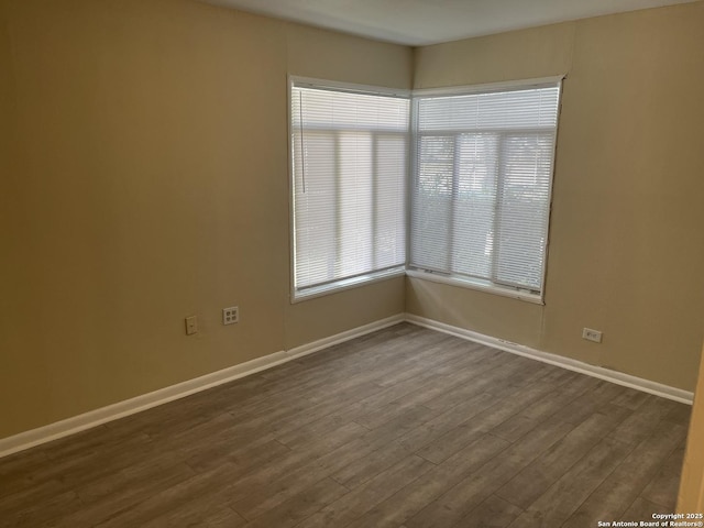 1538 Thorain, San Antonio, TX 78201 - spare room with baseboards and dark wood-type flooring