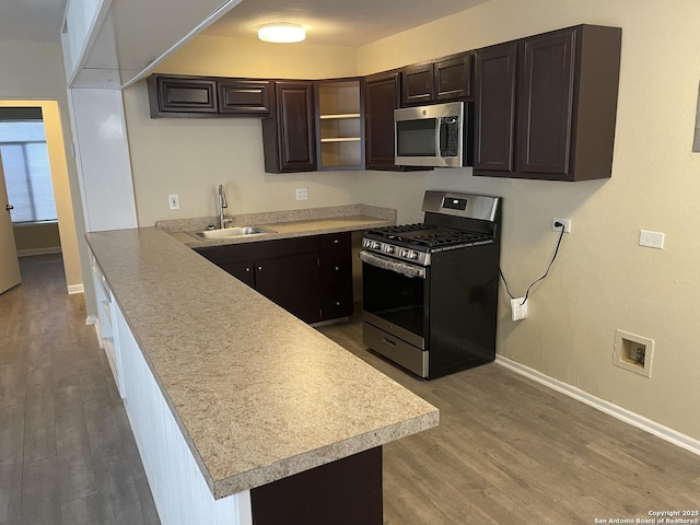 1538 Thorain, San Antonio, TX 78201 - kitchen with appliances with stainless steel finishes, a sink, light wood-style flooring, and dark brown cabinetry