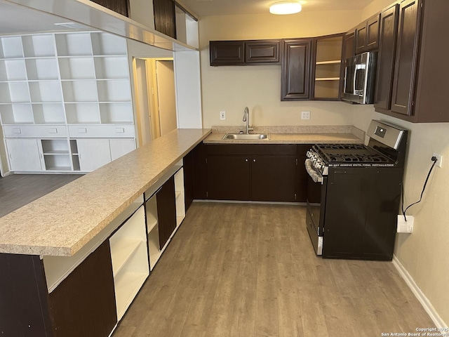 1538 Thorain, San Antonio, TX 78201 - kitchen with appliances with stainless steel finishes, a sink, dark brown cabinets, open shelves, and light wood-type flooring