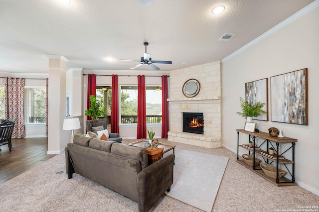 25318 Pleasant Bch, San Antonio, TX 78255 - living area featuring ornamental molding, ceiling fan, baseboards, a fireplace, and a textured ceiling