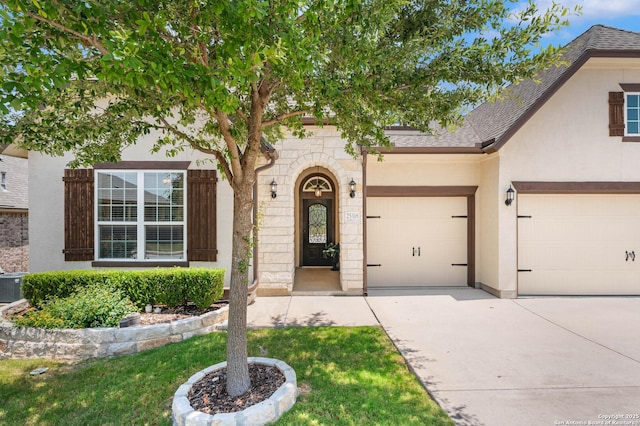 25318 Pleasant Bch, San Antonio, TX 78255 - view of front of home featuring concrete driveway, roof with shingles, stucco siding, and a garage