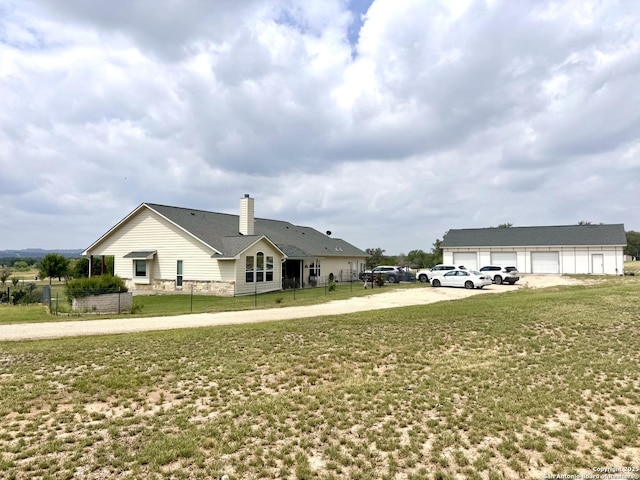 187 Tracks Trl, Center Point, TX 78010 - view of side of property featuring a chimney, concrete driveway, and a detached garage