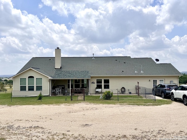 187 Tracks Trl, Center Point, TX 78010 - back of house featuring a chimney and a patio area