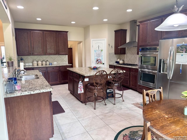 187 Tracks Trl, Center Point, TX 78010 - kitchen with stainless steel appliances, a sink, wall chimney range hood, backsplash, and recessed lighting