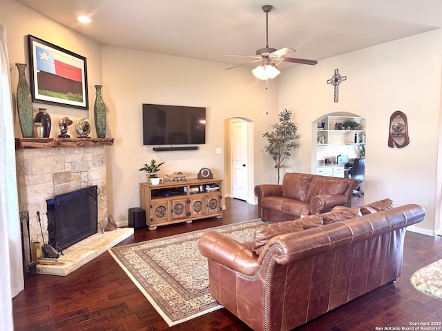 187 Tracks Trl, Center Point, TX 78010 - living area with ceiling fan, arched walkways, dark wood-style flooring, a fireplace, and recessed lighting