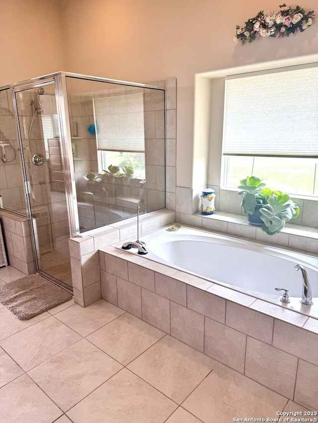 187 Tracks Trl, Center Point, TX 78010 - bathroom featuring a bath, a shower stall, and tile patterned flooring