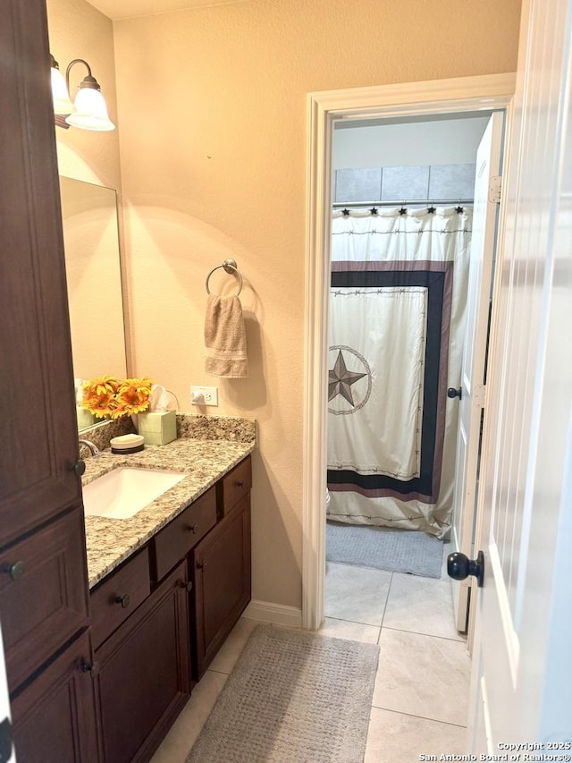187 Tracks Trl, Center Point, TX 78010 - bathroom featuring vanity, tile patterned flooring, baseboards, and a shower with shower curtain