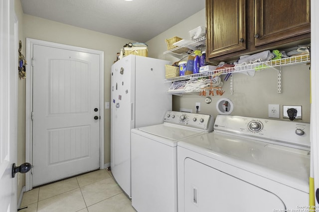 187 Tracks Trl, Center Point, TX 78010 - washroom featuring cabinet space, washing machine and dryer, and light tile patterned floors