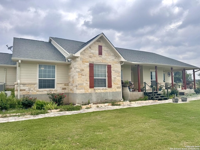187 Tracks Trl, Center Point, TX 78010 - view of front of home featuring stone siding, a porch, a front lawn, and a shingled roof