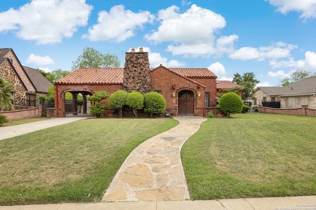 2150 W Summit Ave, San Antonio, TX 78201 - mediterranean / spanish-style house with a tiled roof, a chimney, and a front yard