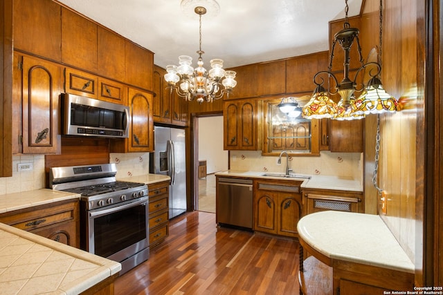 2150 W Summit Ave, San Antonio, TX 78201 - kitchen with stainless steel appliances, a sink, a chandelier, and decorative backsplash