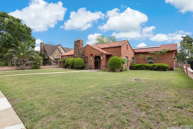 2150 W Summit Ave, San Antonio, TX 78201 - view of front of house with solar panels, a tiled roof, a chimney, and brick siding