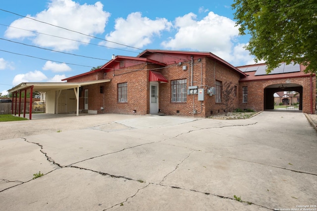 2150 W Summit Ave, San Antonio, TX 78201 - view of front of home featuring driveway, brick siding, crawl space, and solar panels