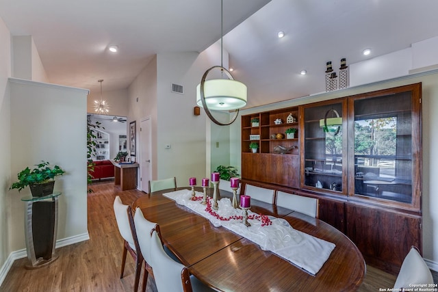 8537 Classic Oaks Ln, San Antonio, TX 78255 - dining room with wood finished floors, lofted ceiling, baseboards, a ceiling fan, and recessed lighting